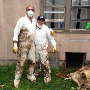 Bruce and Herb after removing flood soaked insulation from a crawl space.