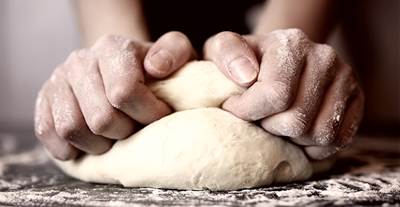 hands kneading dough