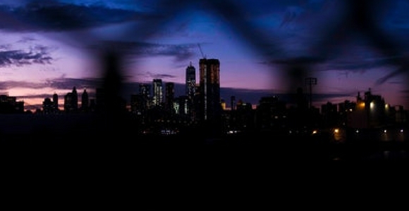City at night behind a fence