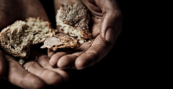 Hands offering bread