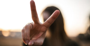 picture of woman holding up two fingers