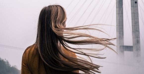 woman looking on the bridge in fog